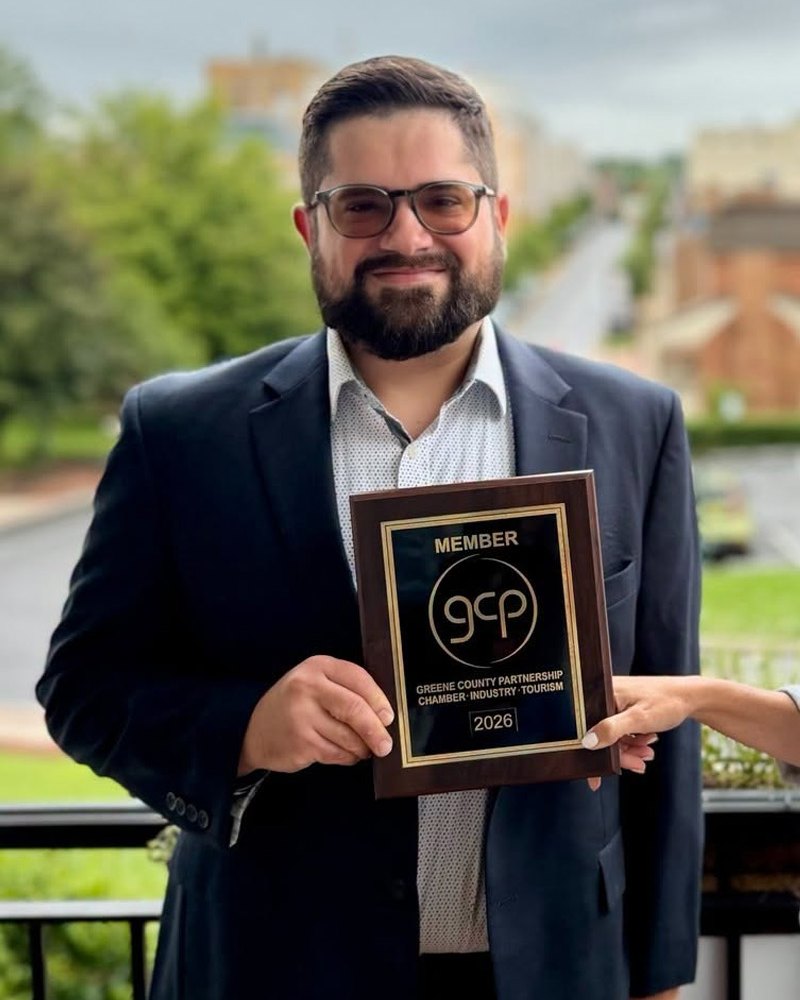 Brian G. of Made in Greene holding the Greene County Partnership member plaque