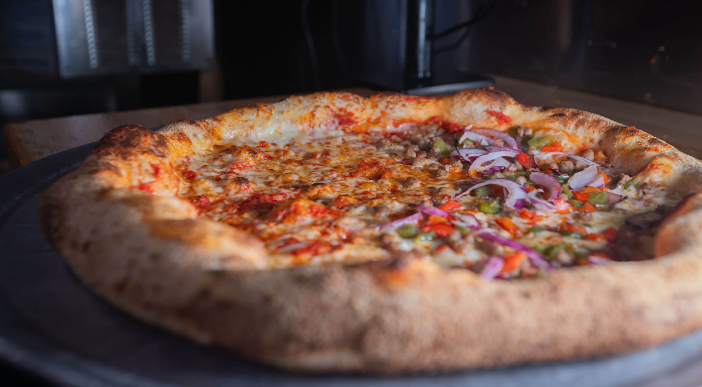 A loaded pizza fresh out of the oven at Rebel Fork Kitchen